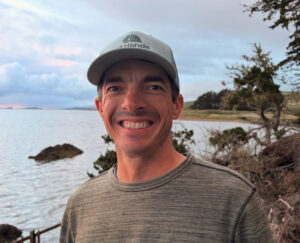 Jim Jensen stands at the edge of Tomales Bay
