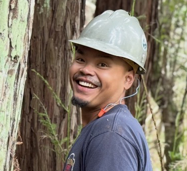 Martin Malate standing among redwood trees