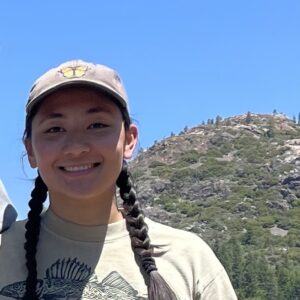 a close up of Jackie Krisilas with a mountain in the background