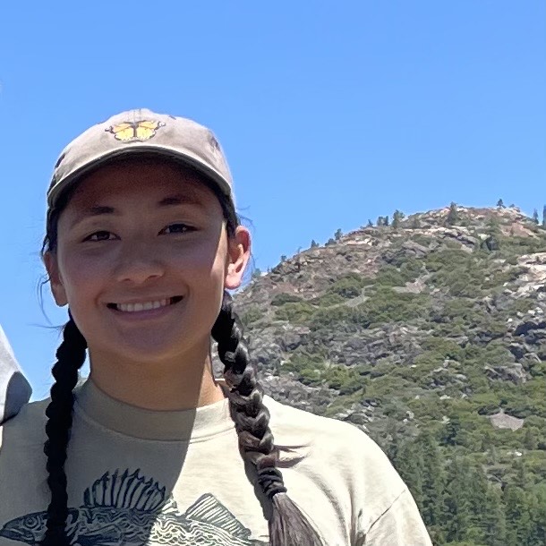 a close up of Jackie Krisilas with a mountain in the background