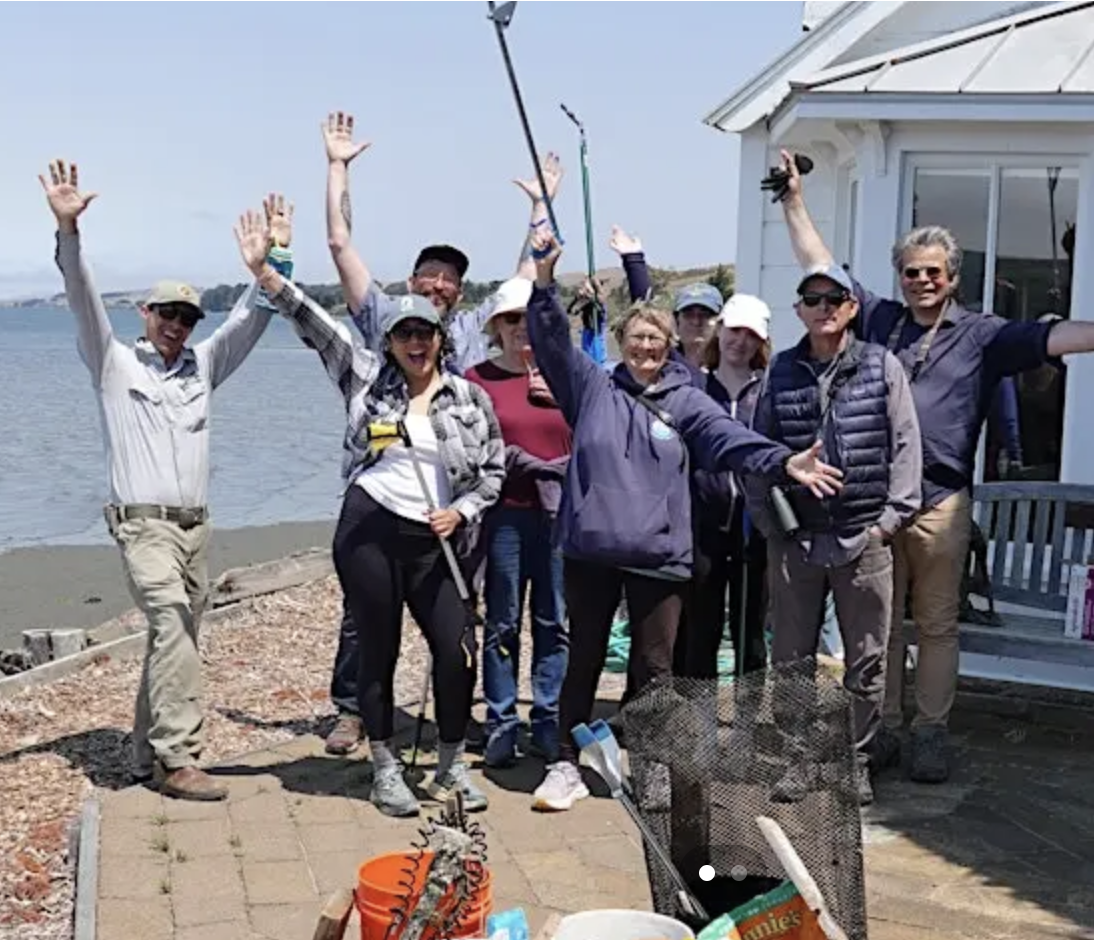 a group of people attending a work day along the Tomals Bay shoreline